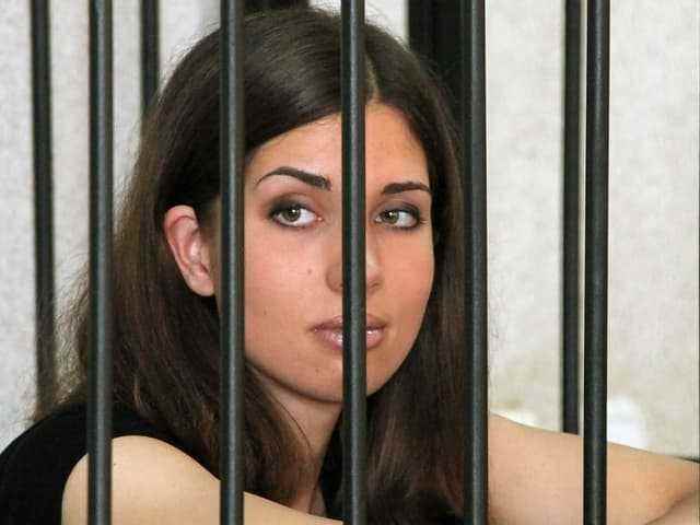 ...and sentencing to long prison terms.  The photo shows Nadezhda Tolokonnikova at a court hearing.  They were released early from prison at the end of 2013.