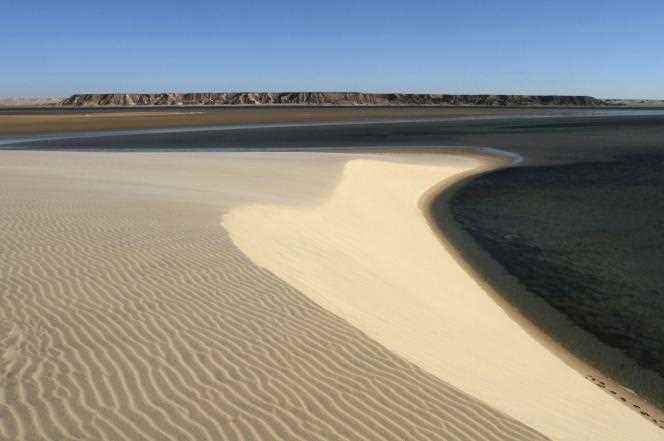The white dune which dominates the eastern shore of the lagoon.