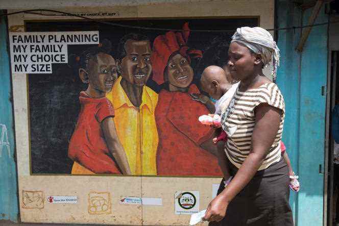 A woman walks past a poster promoting family planning in Nairobi in May 2017.