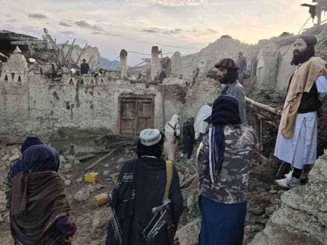 Afghans see the damage caused by the earthquake that hit the province of Paktika, an isolated area in the east of the country, on June 22, 2022.