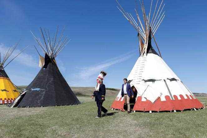 Canadian Prime Minister Justin Trudeau and Siksika Nation Chief Ouray Crowfoot step out of a teepee, at Treaty Flats in the province of Alberta, Canada.  June 2, 2022.