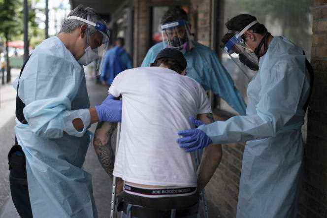 Paramedics treat a drug overdose in downtown Vancouver on June 23, 2021.