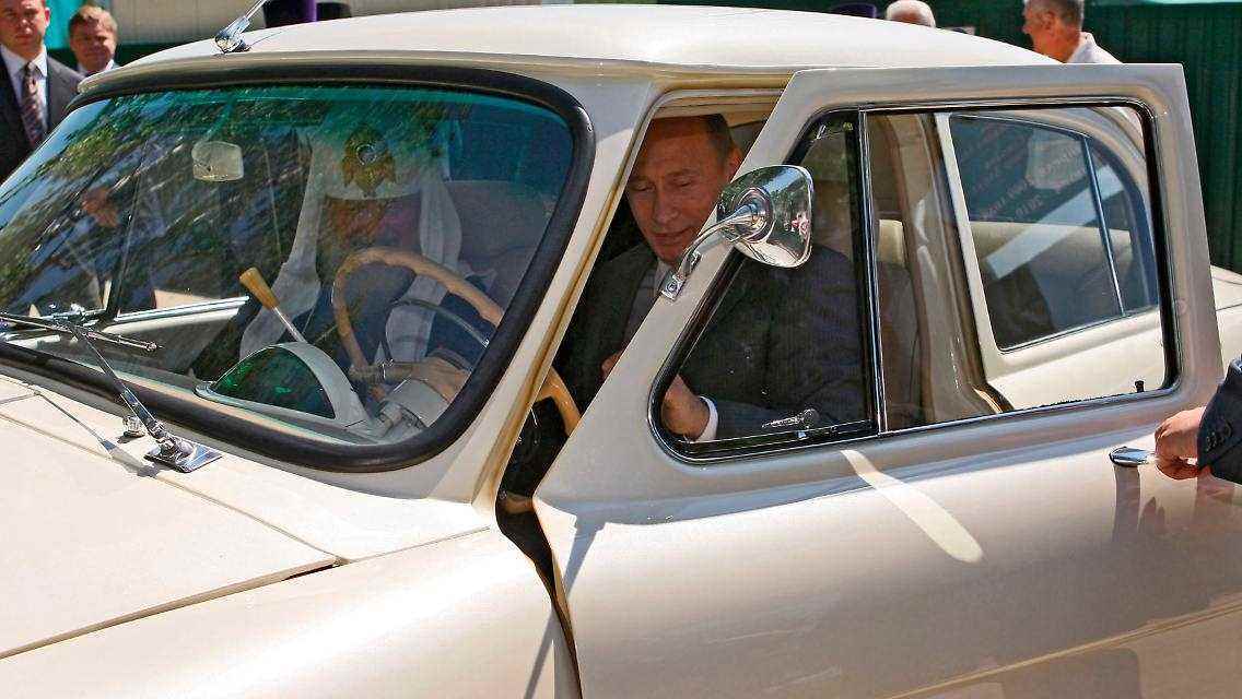 Wladimir Putin am Steuer eines Wolga GAZ-21 neben dem Oberhaupt der russisch-orthodoxen Kirche, Patriarch Kirill.