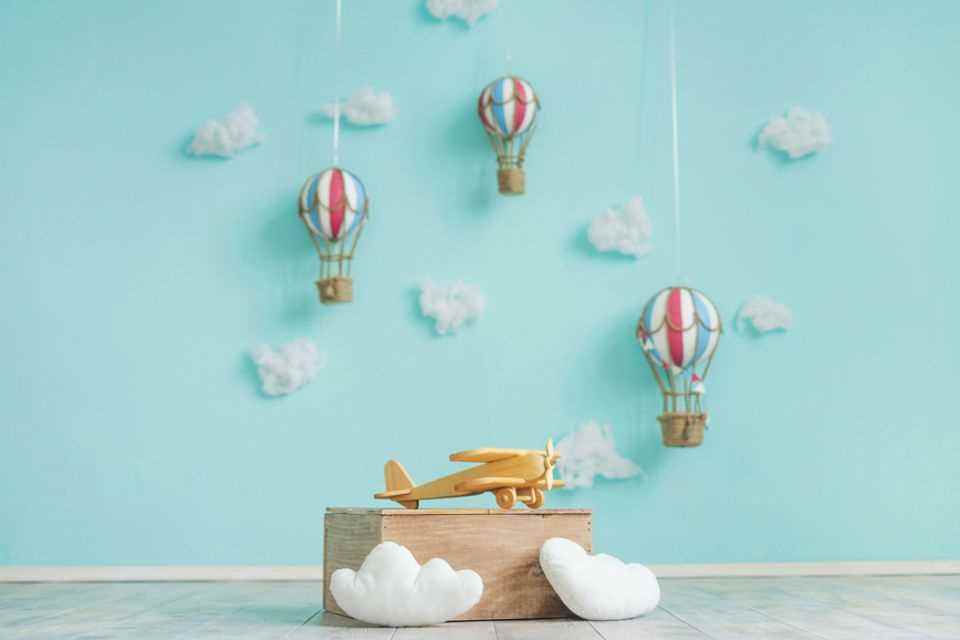 Design children's room: wooden plane and hot air balloons