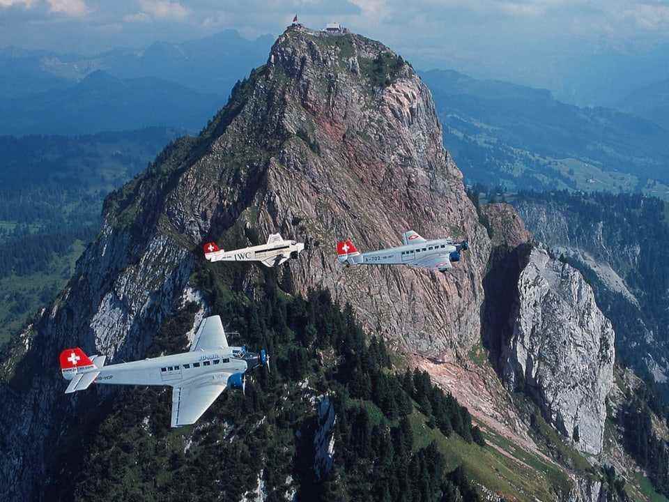 Three planes in front of a mountain