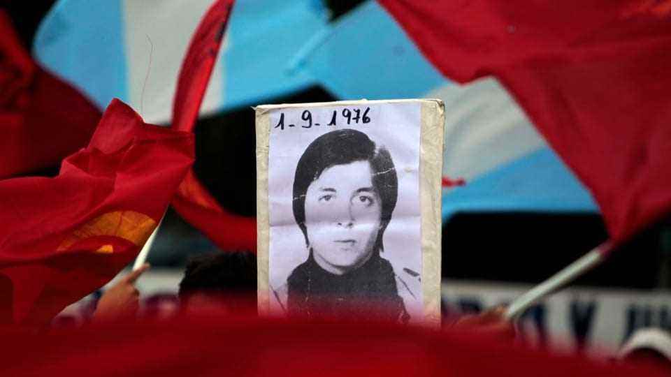 Image of a disappeared woman dated 9/1/1976 in front of Argentina's flag.