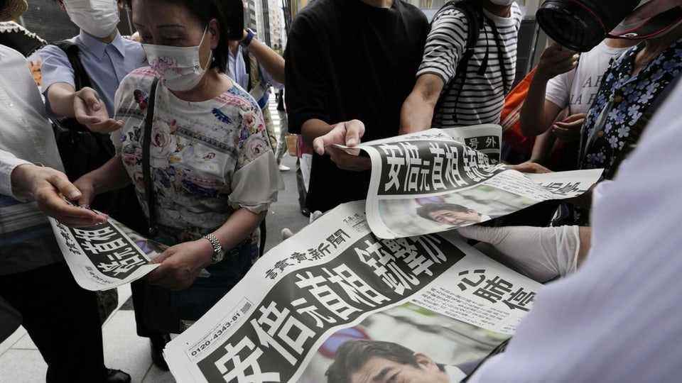 People buying Japanese newspapers