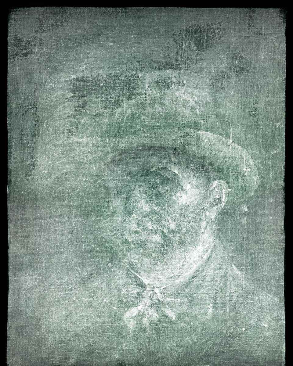 The colorless image shows the bust of a man wearing a hat.  One half of the face is a little out of focus.