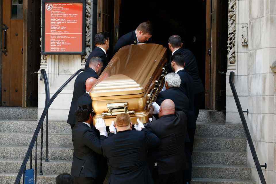 Several men carry Ivana Trump's coffin into St. Vincent Ferrer Church.