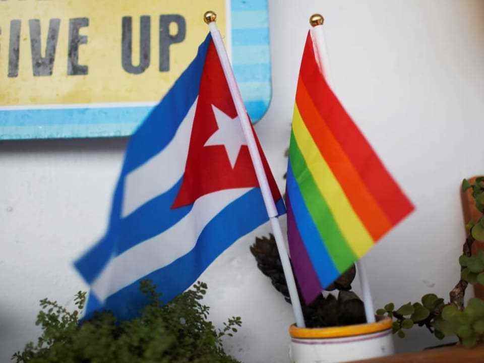 Cuban flag next to rainbow flag