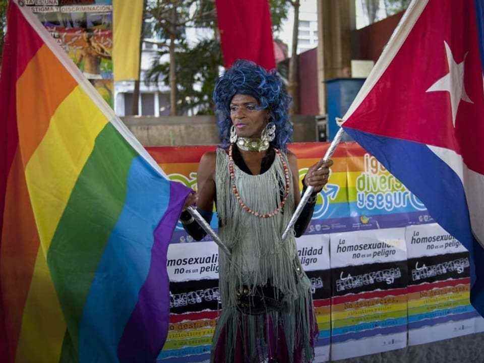 Man with rainbow and cuba flag