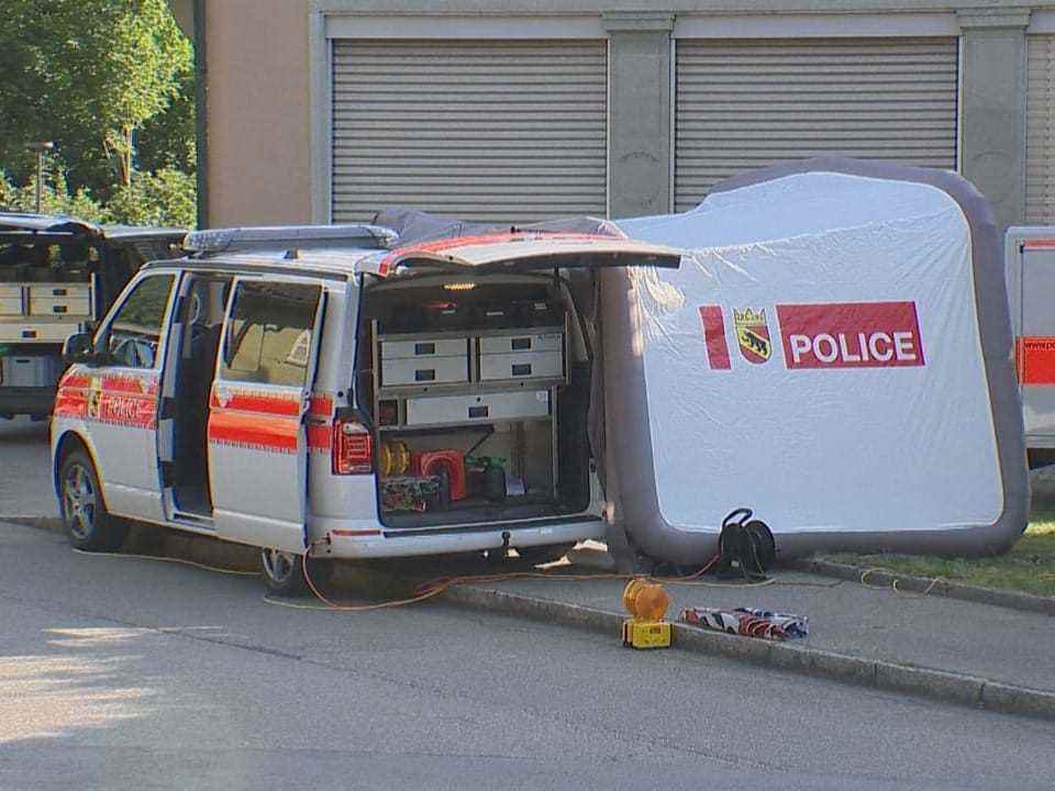 Police vehicles and a tent in Niederbipp.