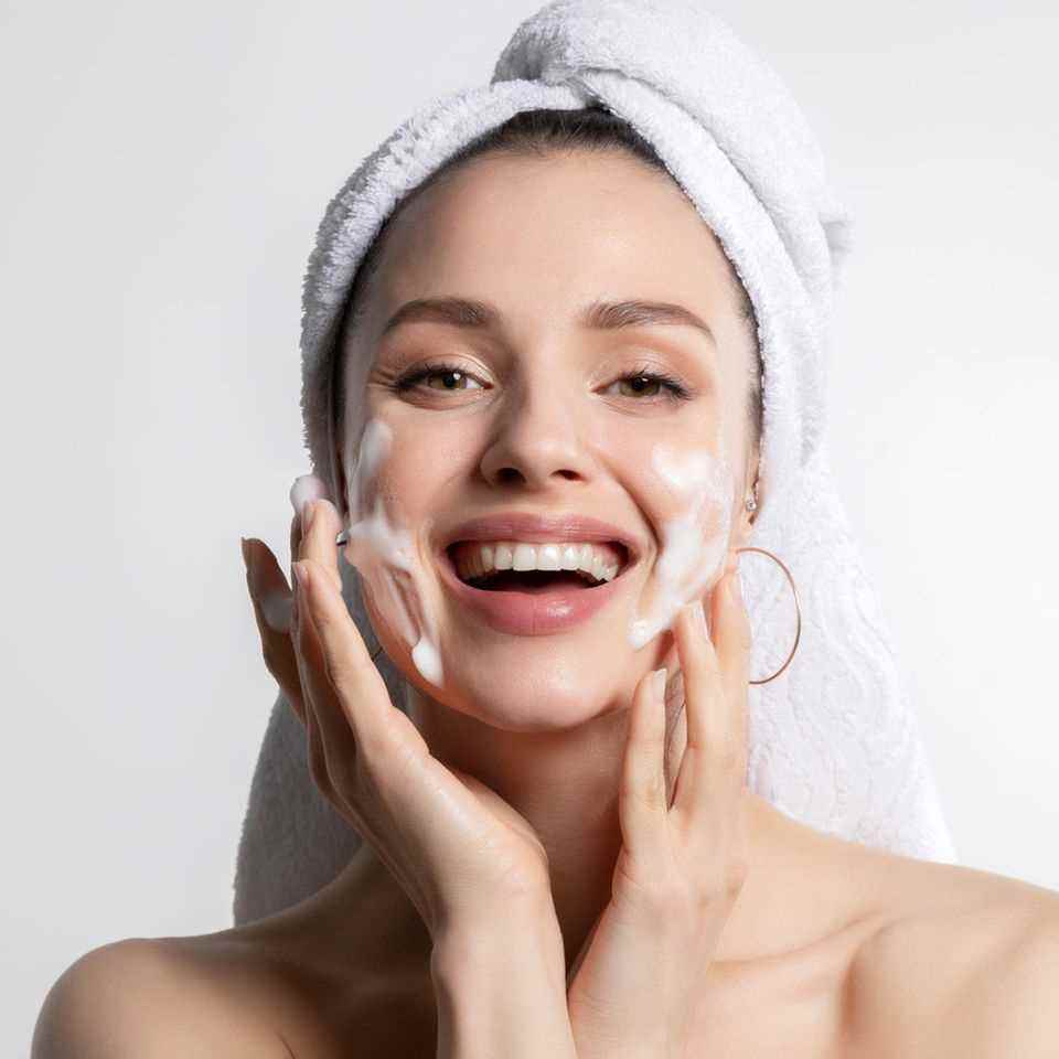 Moisturizer: woman creams face, face care