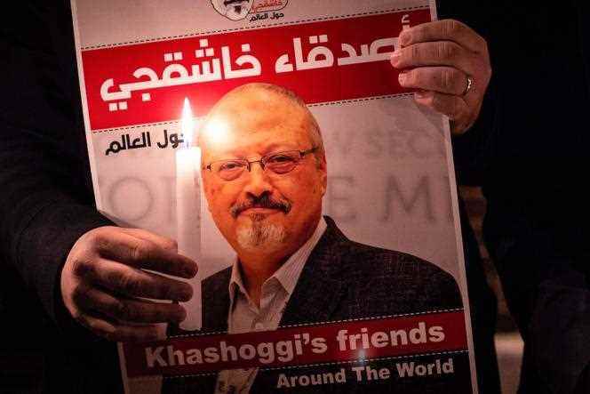 A demonstrator holds a portrait of government critic Jamal Khashoggi and a candle in his hands during a rally in front of the Saudi Arabian consulate in Turkey in Istanbul on October 25, 2018. 
