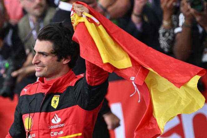Ferrari driver Carlos Sainz celebrates his victory at the British Grand Prix by waving the Spanish flag, Sunday July 3 in Silverstone, England. 