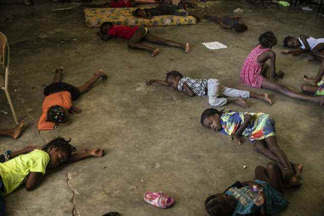 Children sleep on the floor of a school turned into a shelter after being forced to leave their home in Cité-Soleil due to clashes between armed gangs, in Port-au-Prince, Saturday, July 23, 2022. 