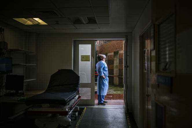 A carer outside the emergency room entrance at Victoria Hospital in Blackpool, UK, June 17, 2020.