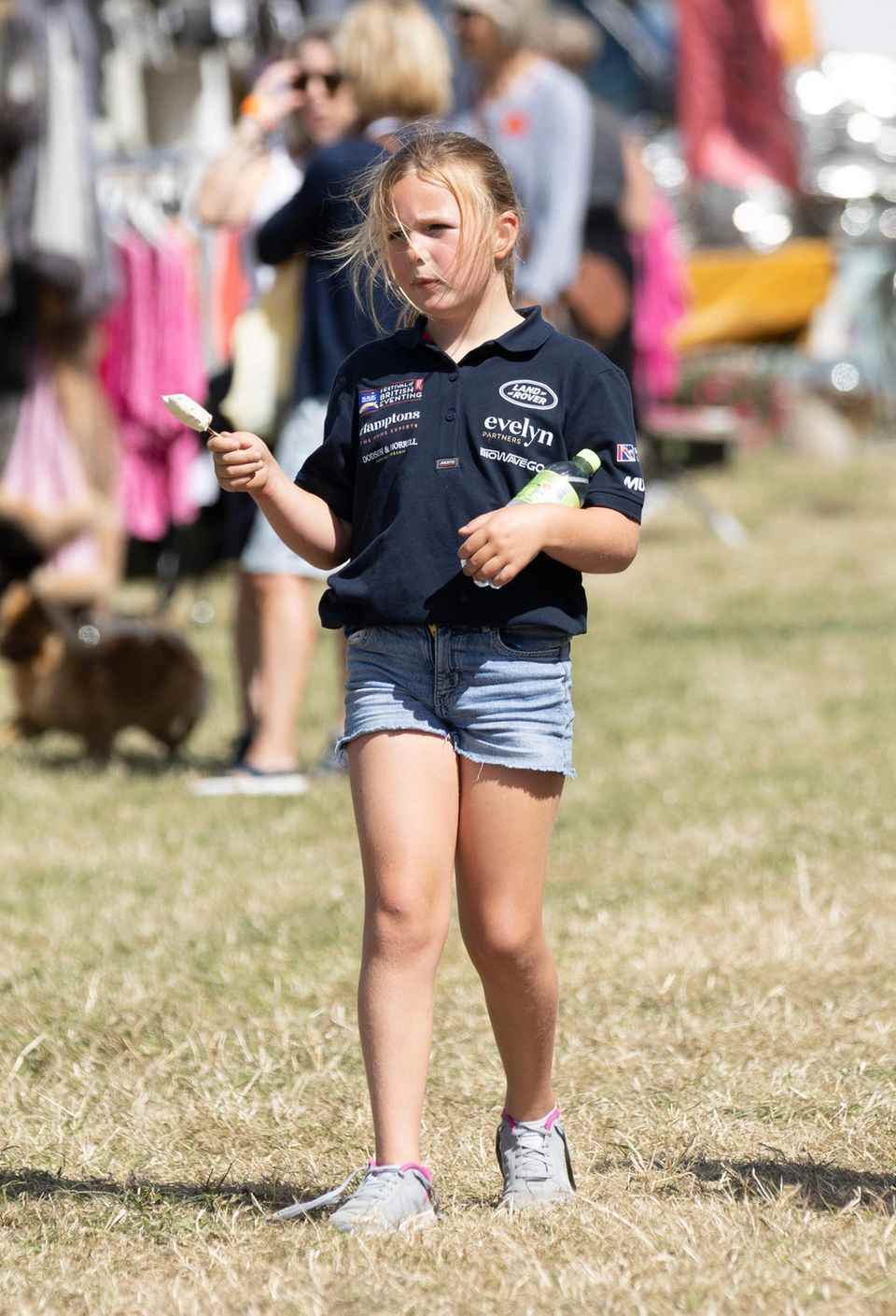 Mia also goes to the horse festival in a shirt and denim shorts