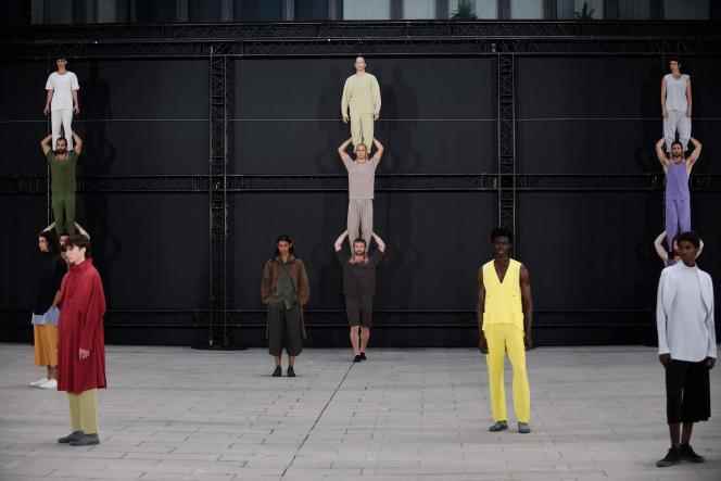 Models, performers and a collective of acrobats present creations by Issey Miyake during a show show as part of Paris Fashion Week, June 23, 2022.
