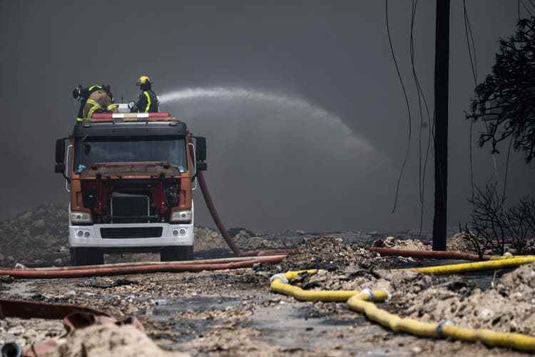 Firefighters work to put out the fire at a major oil storage facility in Matanzas,