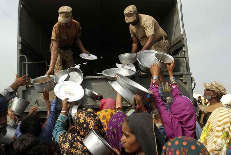 Army personnel distribute food and other relief supplies in Rajanpur, Pakistan's Punjab district, Aug. 27, 2022.