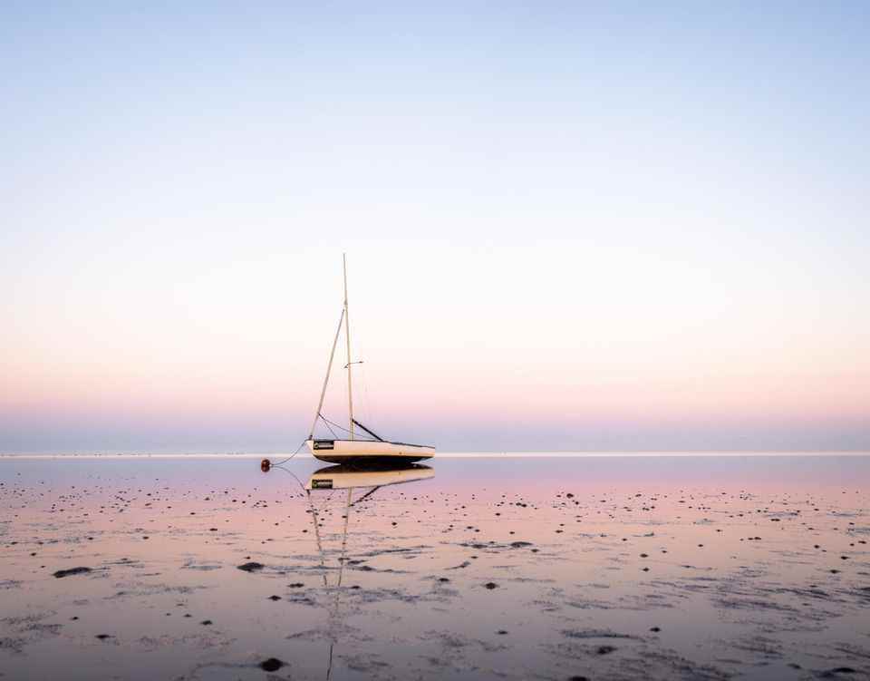 Sailboat at low tide on the beach