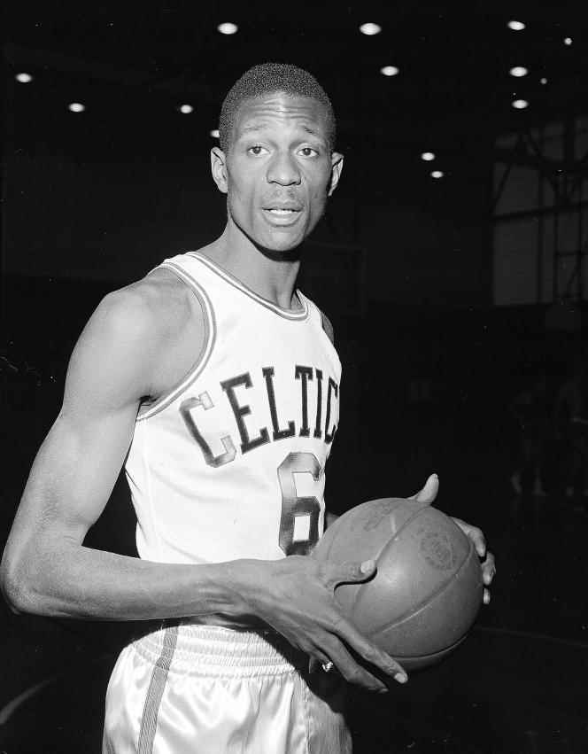 Bill Russell with the Boston Celtics jersey for his first practice session with the NBA team, shortly after signing his contract in Boston, December 19, 1956.  