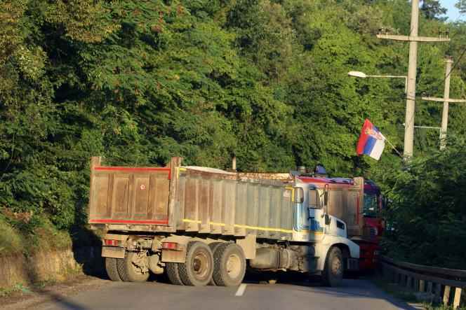 A Serbian flag is seen as trucks block a road in Zupce, Kosovo on August 1, 2022.