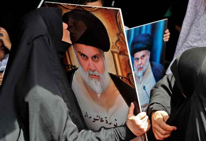 A supporter of Moqtada Al-Sadr kisses her portrait in the 