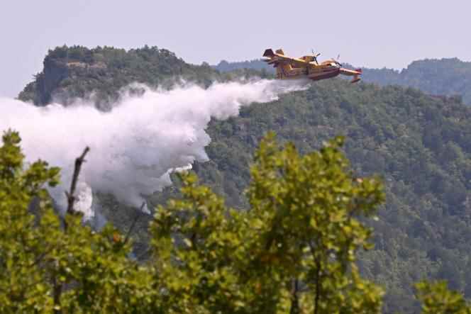 A Canadair drops water on a forest fire in Boyne, southern France, in the Grands Causses regional natural park, on August 9, 2022.