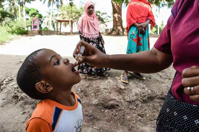 A health worker administers an oral polio vaccine to a child, in Mbezi Makabe, Tanzania, May 21, 2022.
