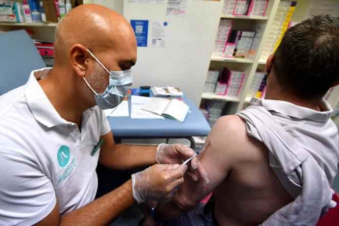 A pharmacist administers a dose of the Imvanex vaccine against the Monkeypox virus, at the Grande Pharmacie de Paris, in Lille, on August 10, 2022.