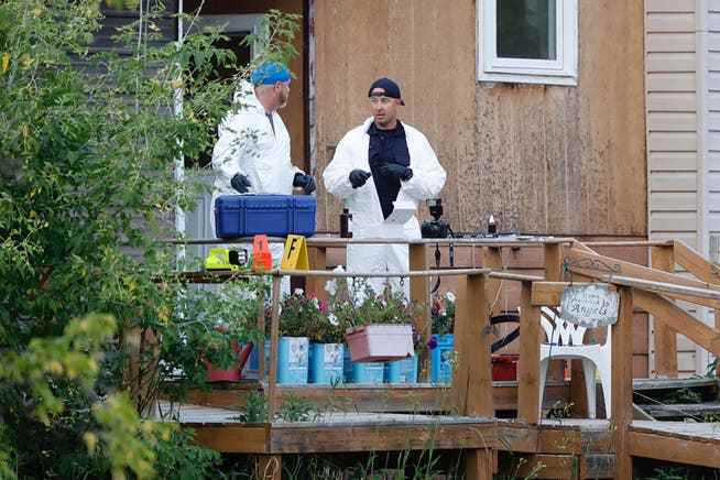 Forensic officers from the Royal Canadian Mounted Police (RCMP) at one of the crime scenes in the township of Weldon.