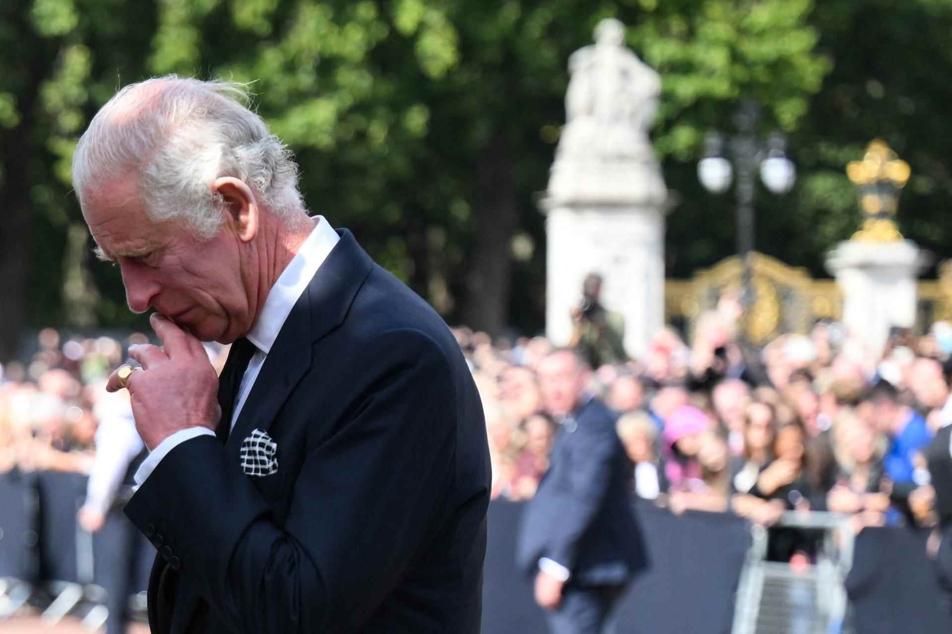 King Charles III in front of the flowers laid in tribute outside Buckingham Palace in London, September 9, 2022.