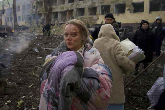 Marianna Vishegirskaya stands outside a maternity ward which was damaged by shelling in Mariupol, Ukraine March 9, 2022. She survived the shelling and gave birth to a daughter at another hospital in Mariupol.
