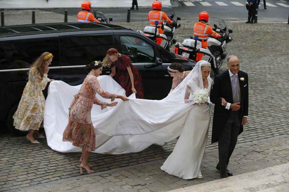 Several bridesmaids have to help carry the skirt to the church
