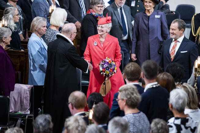 The Danish Queen Margrethe II is greeted by Bishop Peter Skov-Jakobsen on her arrival for the service in Copenhagen Cathedral.
