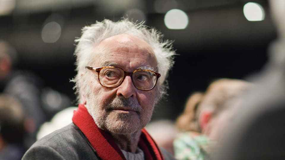Elderly man with beard, glasses and red scarf