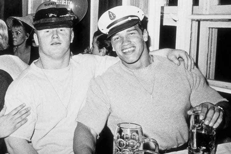 Young bodybuilder Arnold Schwarzenegger poses with a friend at Oktoberfest.  (1967)