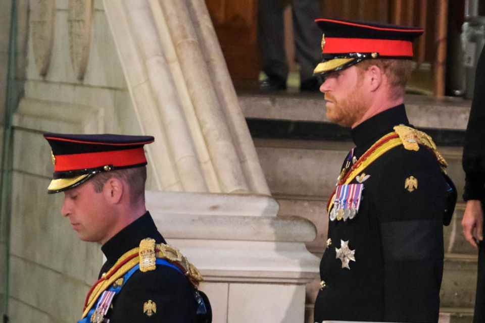 It's worth taking a closer look at the shoulders of Prince William and Prince Harry: While William's initials can be found on the golden border, they have disappeared from Harry's.