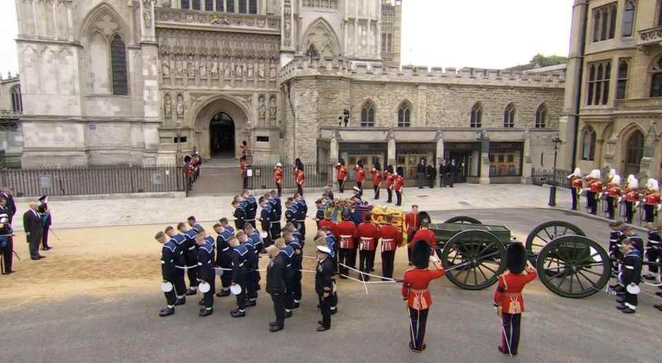 The Queen's coffin is carried into the Abbey.