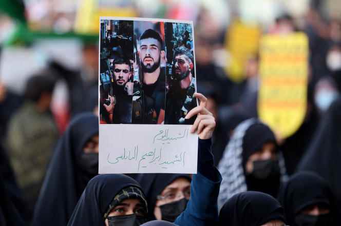 A woman holds up a photo of Ibrahim Al-Nabulsi, killed in an Israeli raid, during a demonstration in support of the Palestinians, in Tehran, August 9, 2022. 