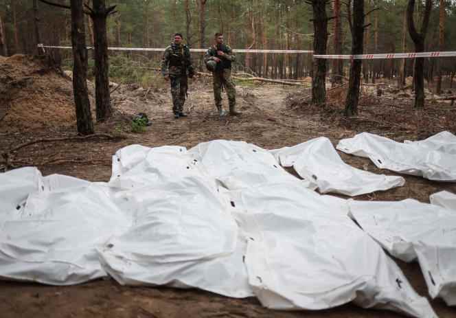 Bodies exhumed at a mass burial site in the city of Izium, Kharkiv region, on September 16, 2022.
