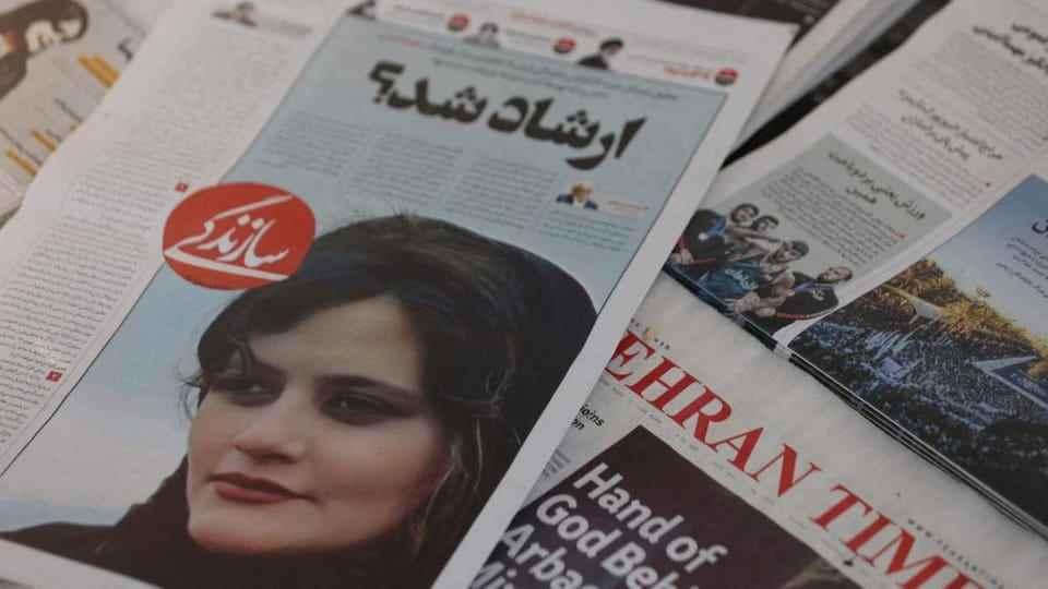 Mahsa Amini's face on an Iranian newspaper.