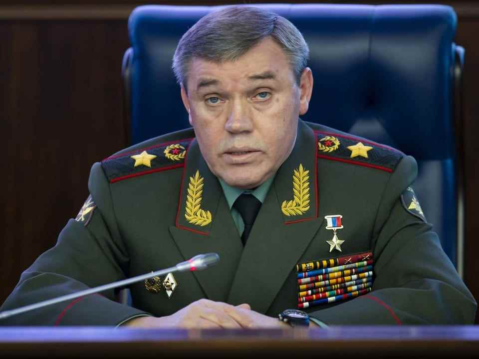 Russian Army Chief of Staff Valery Gerasimov speaks into a microphone during a meeting.
