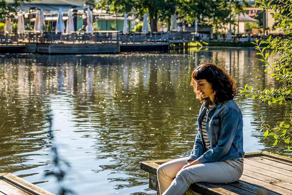 Woman sitting on jetty