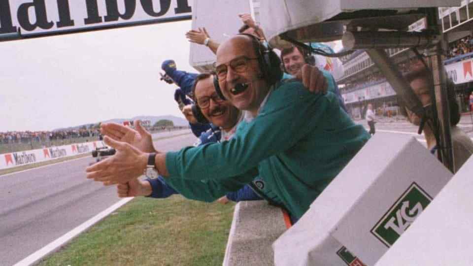 Peter Sauber claps the hands of one of his drivers as he crosses the finish line in Barcelona in 1997.