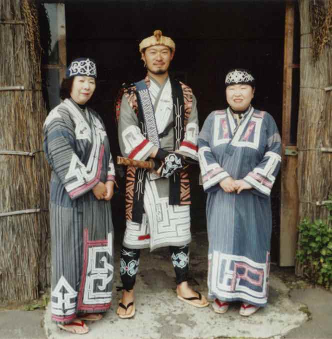In this archive photograph, Ainu people wear their traditional clothing.