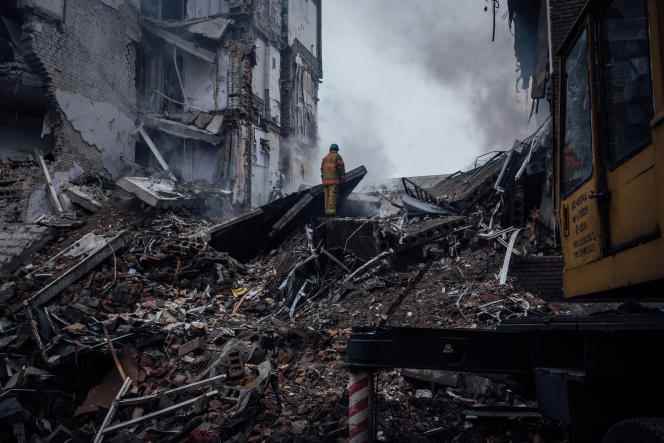 A Ukrainian firefighter inspects the debris of a building destroyed by a Russian strike, in Zaporizhia, October 10, 2022. 