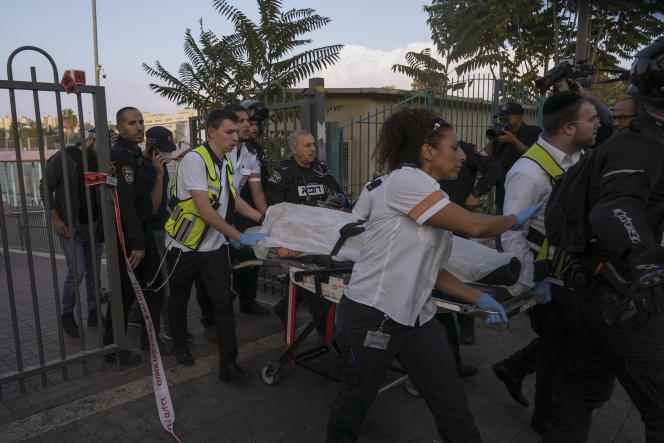 Israeli medics and police carry the suspect of a stabbing attack on an Israeli, after Israeli police shot him, in Jerusalem on October 22, 2022.